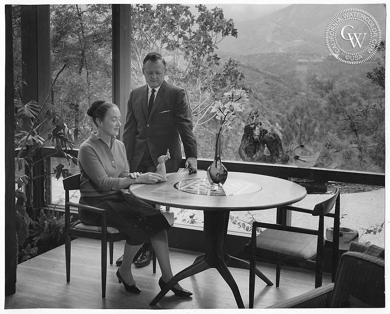 Millard Sheets and his wife sitting at a chess table made by Sam Maloof